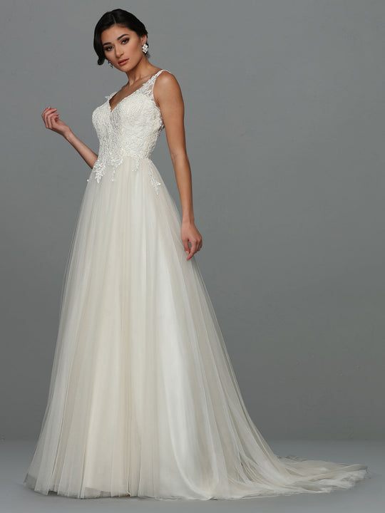 An elegant woman models the Avery Austin "Skylar - Tried On Sample," a sleeveless, floor-length wedding dress in ivory/nude tulle with a lace bodice and flowing A-line skirt, standing against a plain gray background and gazing at the camera.