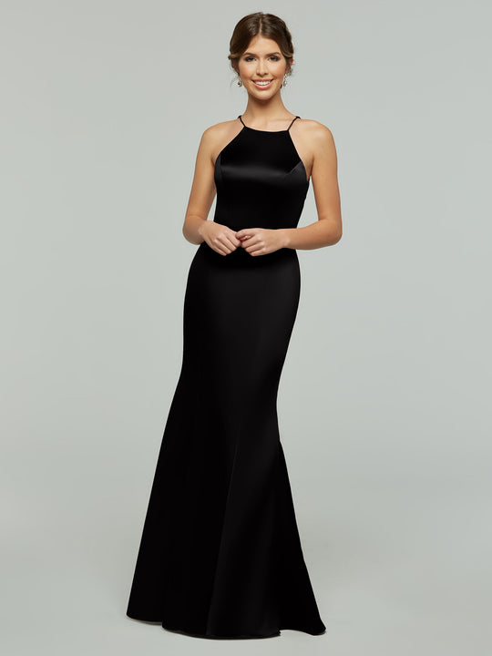 A woman smiles in the Avery Austin 80071, a sleeveless black floor-length fitted dress with a halter neckline and flared skirt, set against a plain light grey background.