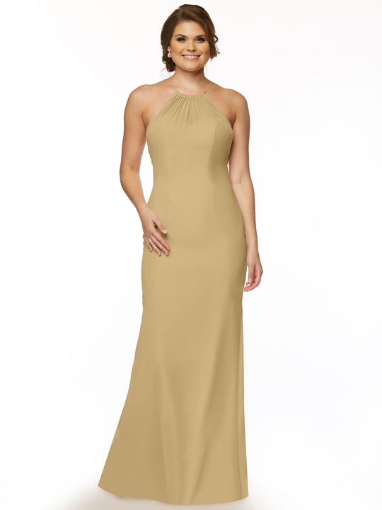 A woman smiles against a white background, wearing Avery Austin style 80083—a sleeveless, floor-length halter chiffon dress in champagne with a keyhole back for added elegance.