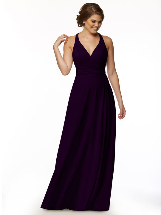 A woman models Avery Austin’s 80107: a sleeveless, floor-length, deep purple A-line dress with a V-neckline, standing against a white background, smiling and touching her hair.