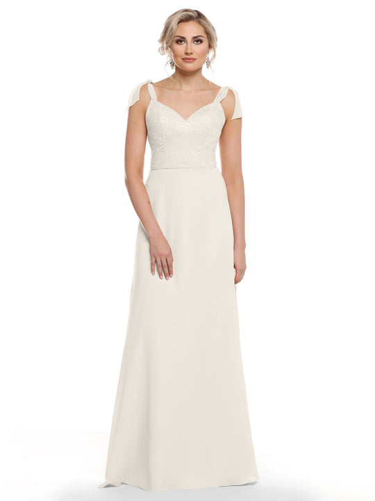 A woman with short blonde hair in soft waves models Avery Austin’s 80149: a floor-length off-white chiffon dress featuring floral lace on the bodice, cap sleeves with shoulder cutouts, and a flowing skirt, against a plain white background.