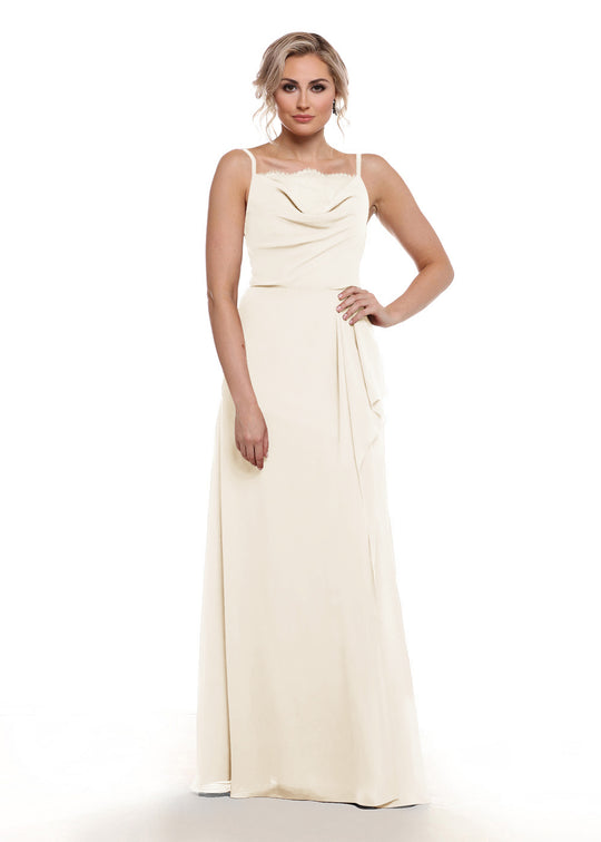 A woman with loose, wavy light hair and a neutral expression wears Avery Austin style 80152, a long, sleeveless cream chiffon A-line dress with a draped neckline and fitted waist, standing against a plain white background.