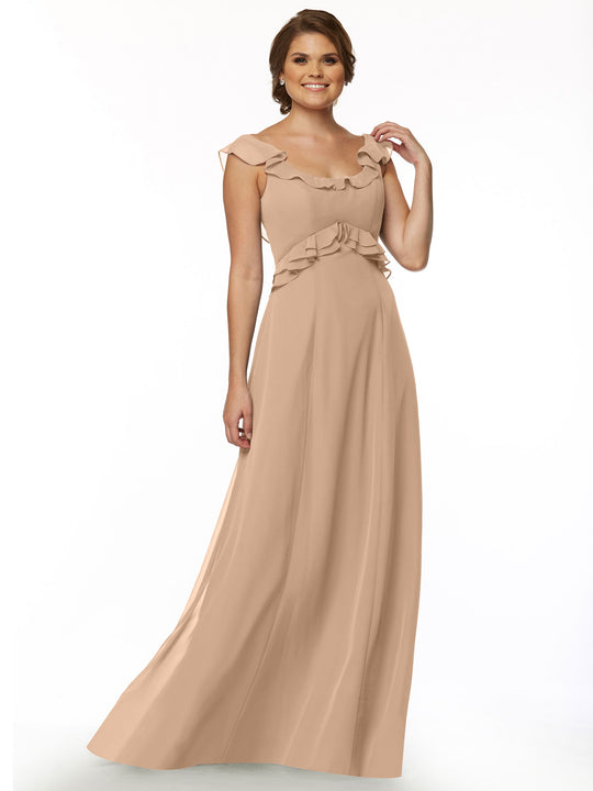 A woman stands smiling against a plain white background, wearing Avery Austin's long, light beige dress 80173 with a ruffled neckline and delicate ruffle details on the shoulders and waist.