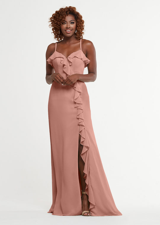 A woman models Avery Austin’s product 80174: a blush pink, floor-length A-line dress with spaghetti straps, ruffle neckline, and cascading ruffle beside a thigh-high slit, shown against a plain white background.