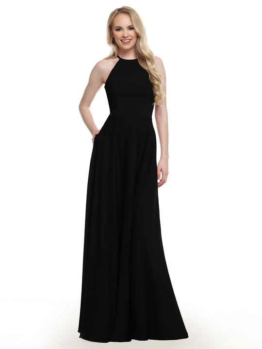 A woman with long blonde hair models Avery Austin’s 83022, a sleeveless, floor-length black gown with an A-line skirt, smiling against a plain white background.