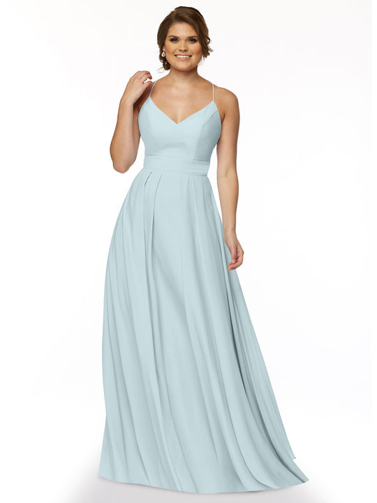A woman in a Sky Blue Avery Austin A-Line floor-length dress (style 83027) with spaghetti straps, a fitted bodice, and a flowing skirt stands smiling against a plain white background.