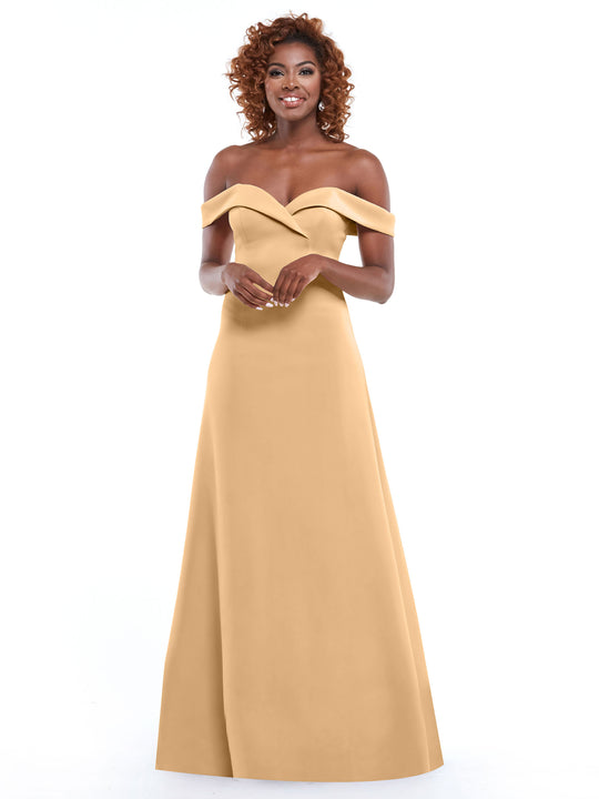 A woman wearing the Avery Austin 83050 A-line dress in bisque stands smiling against a white background with her hands gently clasped in front of her.