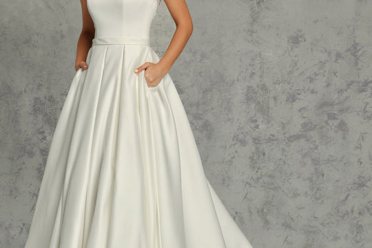 Bride wearing the Penelope satin A-line wedding dress by Avery Austin, a simple silhouette suited to spring wedding venues