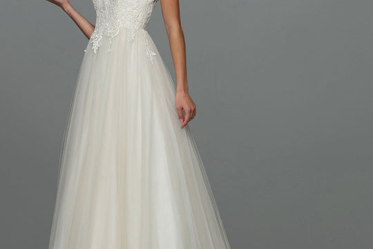 Model wearing the Avery Austin Skylar lace and tulle A-line wedding dress in Ivory/Nude, one of the sample wedding dresses on sale