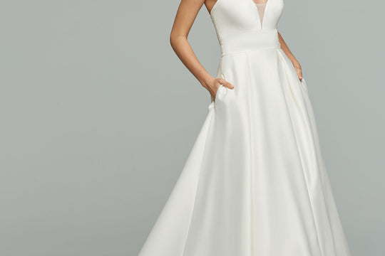Bride in an Avery Austin try-at-home wedding dress posing for portraits at home