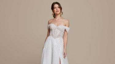 Bride wearing an off-the-shoulder long white vow renewal wedding dress.