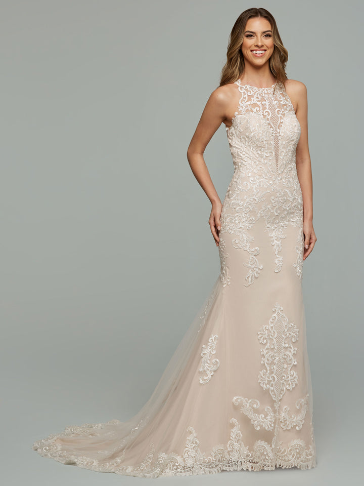 A woman smiles against a light gray background, wearing the "Paris" wedding dress by averyaustin in Ivory/Rosewater—an illusion lace, sleeveless, floor-length gown with a high neckline and intricate embroidery.