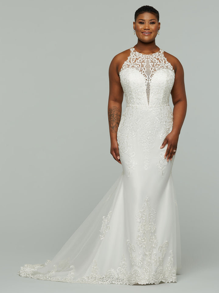 A woman in the averyaustin Paris wedding dress, featuring a sleeveless fitted illusion lace design with a sheer high neckline and elegant lace details in Ivory/Rosewater, smiles against a plain gray background.