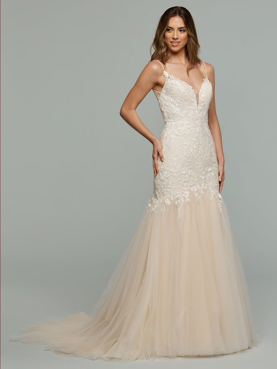 A woman poses against a light grey background wearing the Imani - Tried On Sample by averyaustin, a fitted ivory mermaid wedding dress with a lace bodice and tulle skirt.