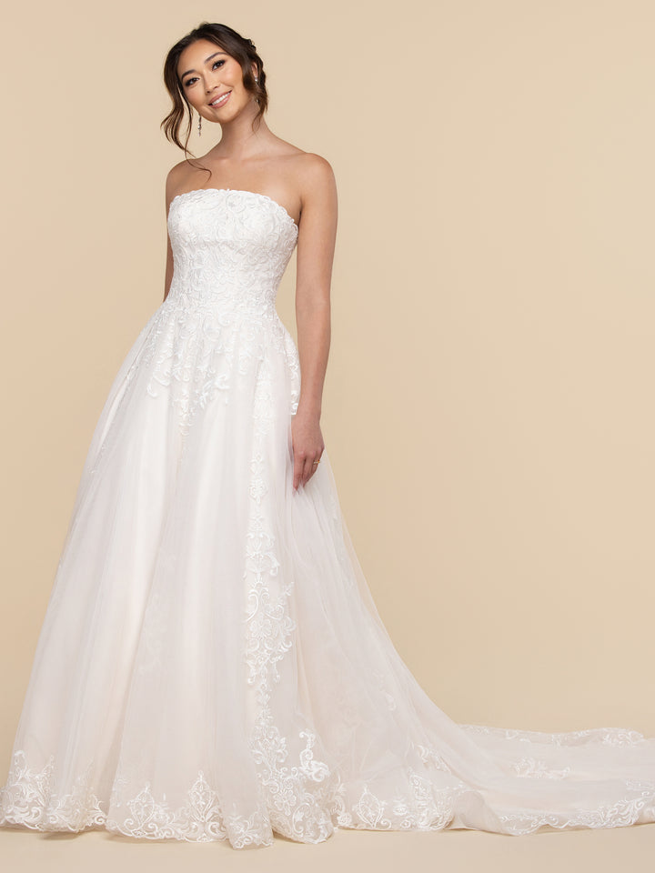 AveryAustin Noelle wedding dress in ivory and sand, featuring a romantic, strapless bodice with lace appliqués and a tulle A-line skirt with a train.