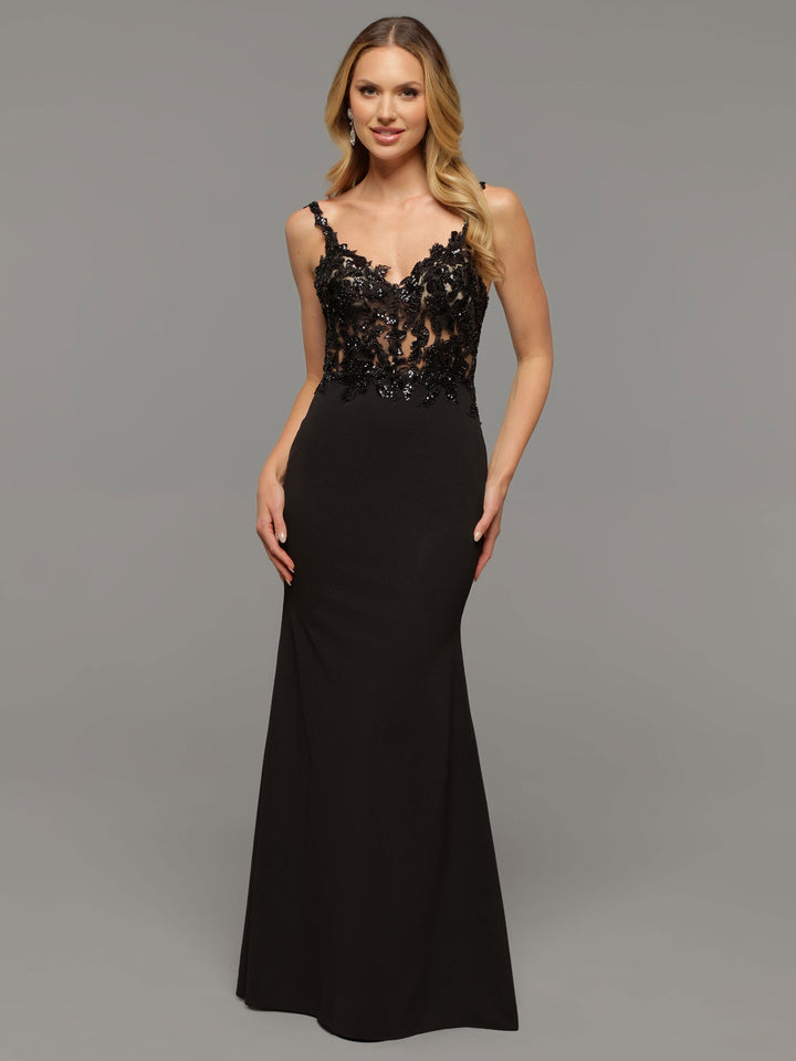 A woman poses against a plain gray background, wearing the averyaustin June gown in Black/Nude—a sleeveless, floor-length dress with a fitted bodice adorned with beaded lace and a long, sleek skirt.
