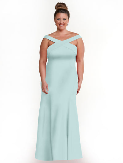 A woman smiles in front of a white background, wearing Avery Austin’s sky blue floor-length A-line dress (style 83048) with off-the-shoulder crisscross straps, her hair styled in a high bun and accessorized with dangling earrings.