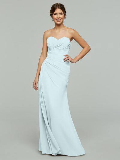 A woman poses against a plain gray background in Avery Austin's 80028, a strapless floor-length chiffon dress with a ruched bodice, relaxed fit, and subtle sweetheart neckline.