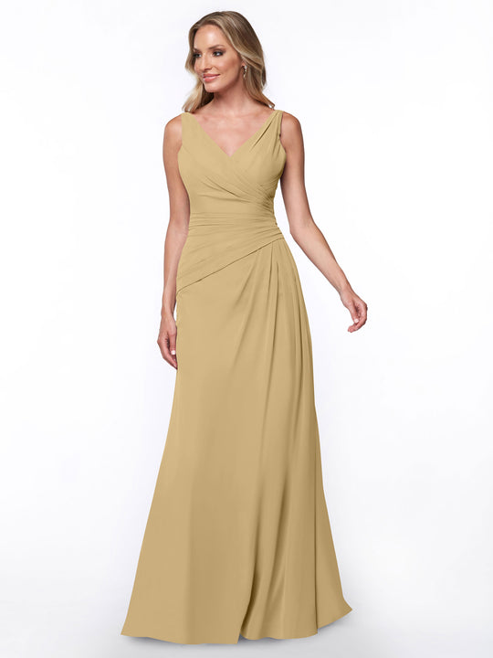A woman wearing the Avery Austin 80030 sheath dress in champagne, featuring a V-neck and ruched bodice, stands against a white background, smiling and looking slightly to her left.