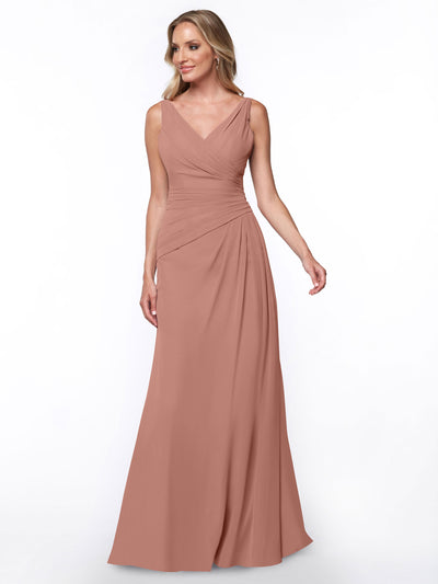A woman models Avery Austin style 80030—a sleeveless, floor-length dusty rose sheath dress with a V-neck and ruched waist—standing against a plain white background.
