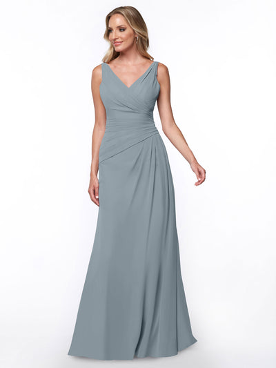 A woman models Avery Austin's 80030: a sleeveless, floor-length sheath dress in dusty blue with a V-neckline and ruched bodice, set against a plain white background.