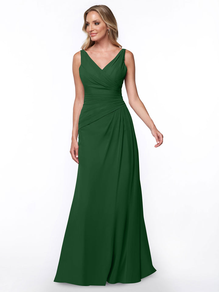 A woman models Avery Austin’s 80030, a sleeveless floor-length dark green evening gown with a ruched bodice and V-neckline, standing against a plain white background.