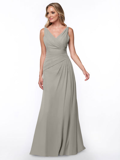 A woman models Avery Austin’s 80030: a long, light gray sheath dress featuring a ruched bodice and V-neckline, set against a plain white background.