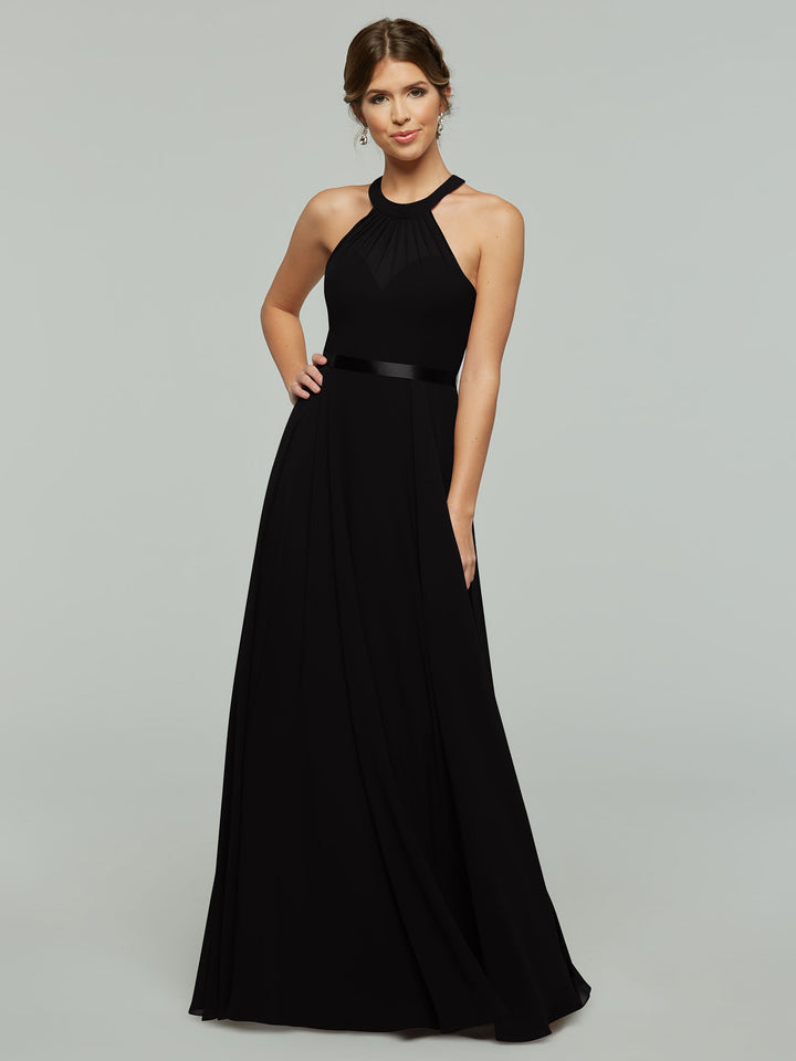 A woman wears a long Black halter-neck evening gown with a fitted waist and flowing skirt.