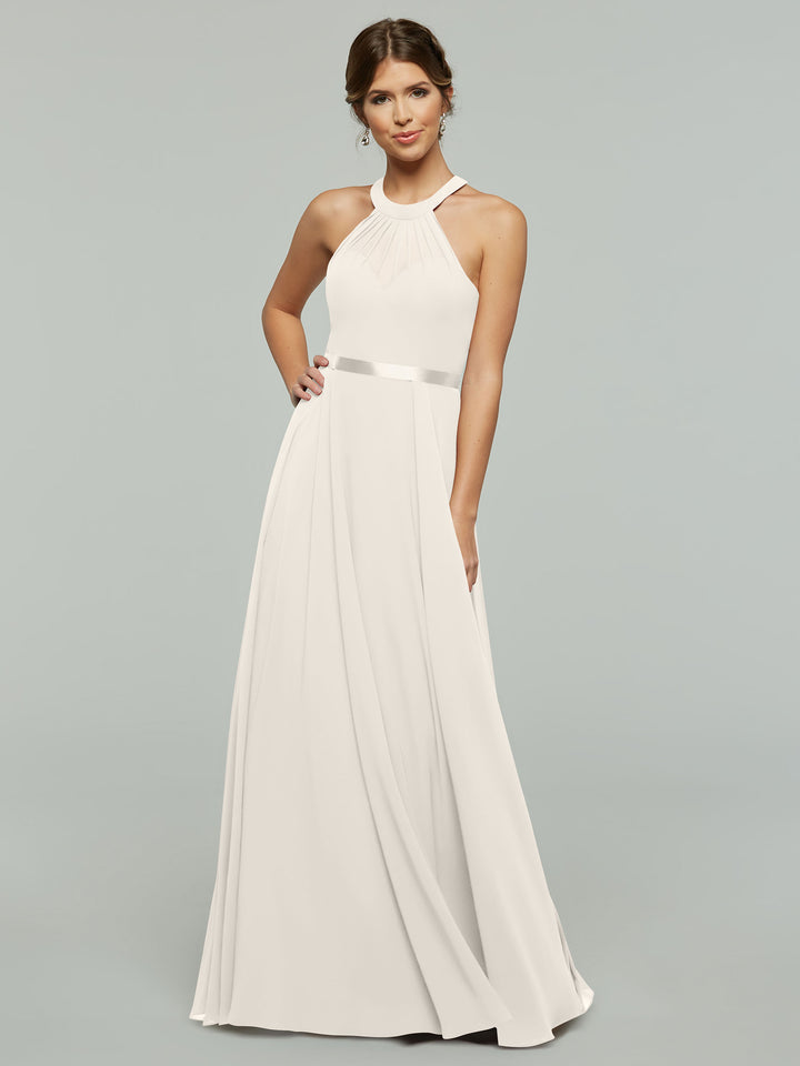 A woman wears a flowing ivory halter-neck wedding dress with a ribbon accent at the waist.