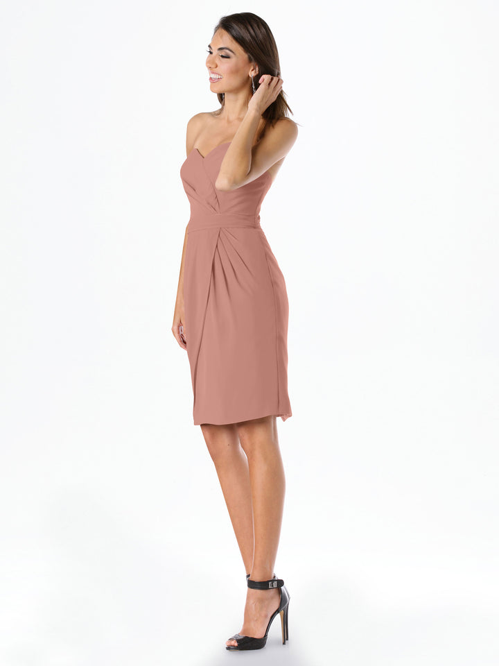 A woman stands sideways against a white background, wearing Avery Austin&