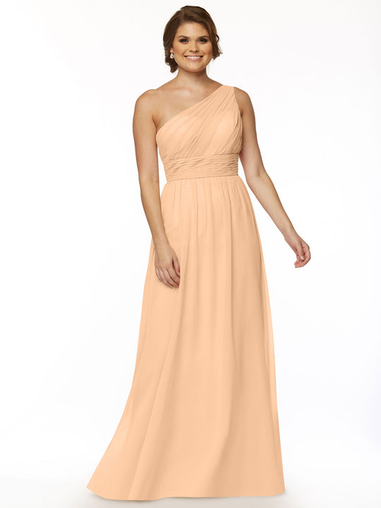 A woman smiles against a white background wearing Avery Austin’s TH-80047: a long, peach one-shoulder chiffon dress featuring a fitted waist and ruched bodice.