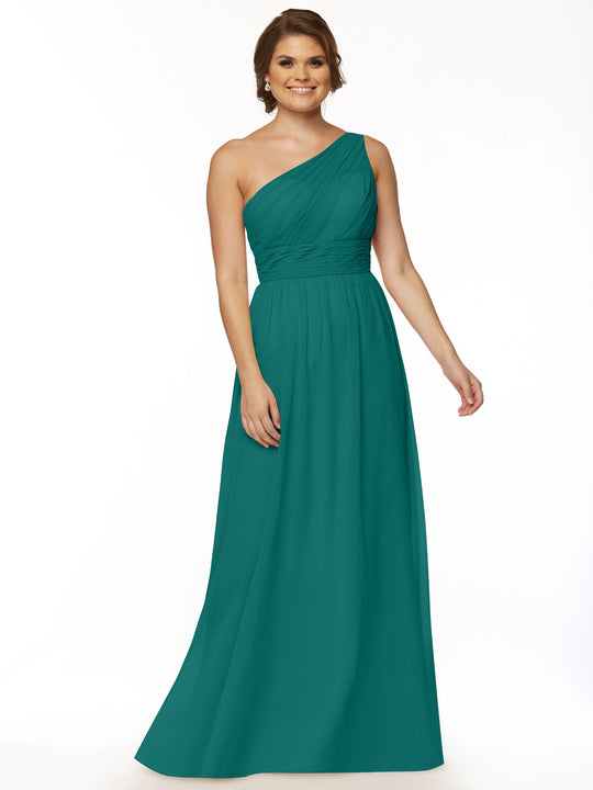 A woman smiles against a white background, wearing Avery Austin’s 80047: a teal, one-shoulder chiffon dress with a fitted pleated bodice and modern twist detail paired with a flowing skirt.