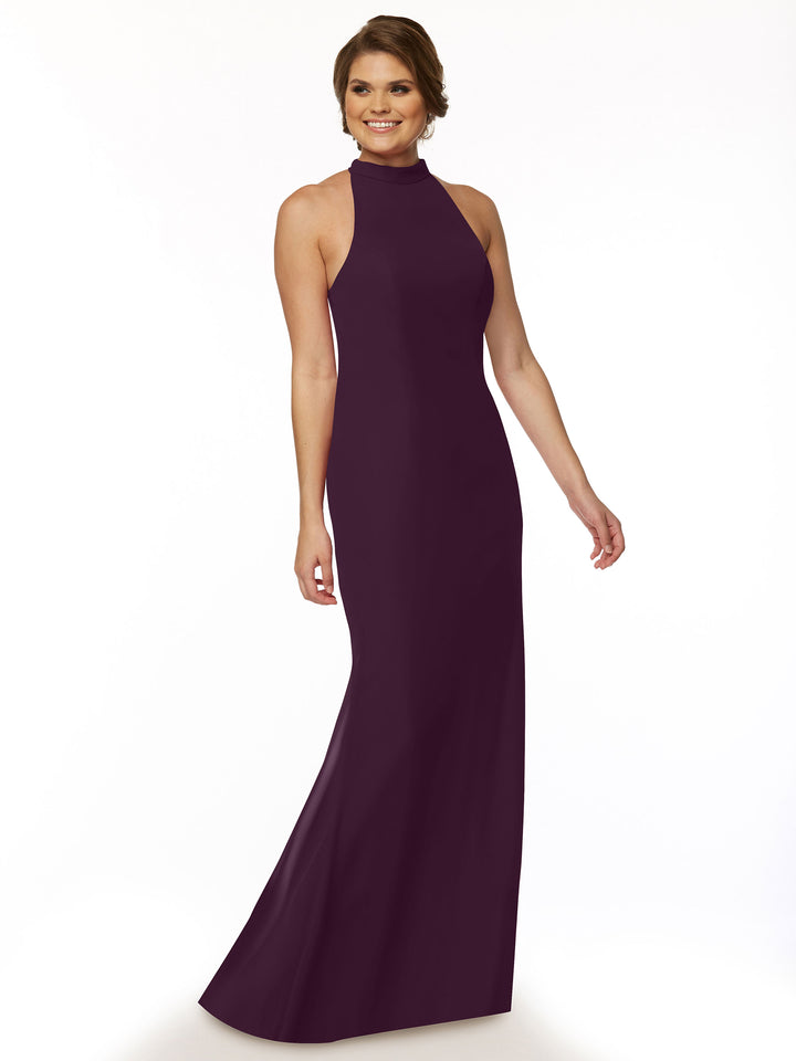 A woman in the Avery Austin 80068 sleeveless, floor-length chiffon bridesmaid dress in Aubergine with a high neckline stands against a plain white background, smiling gently.