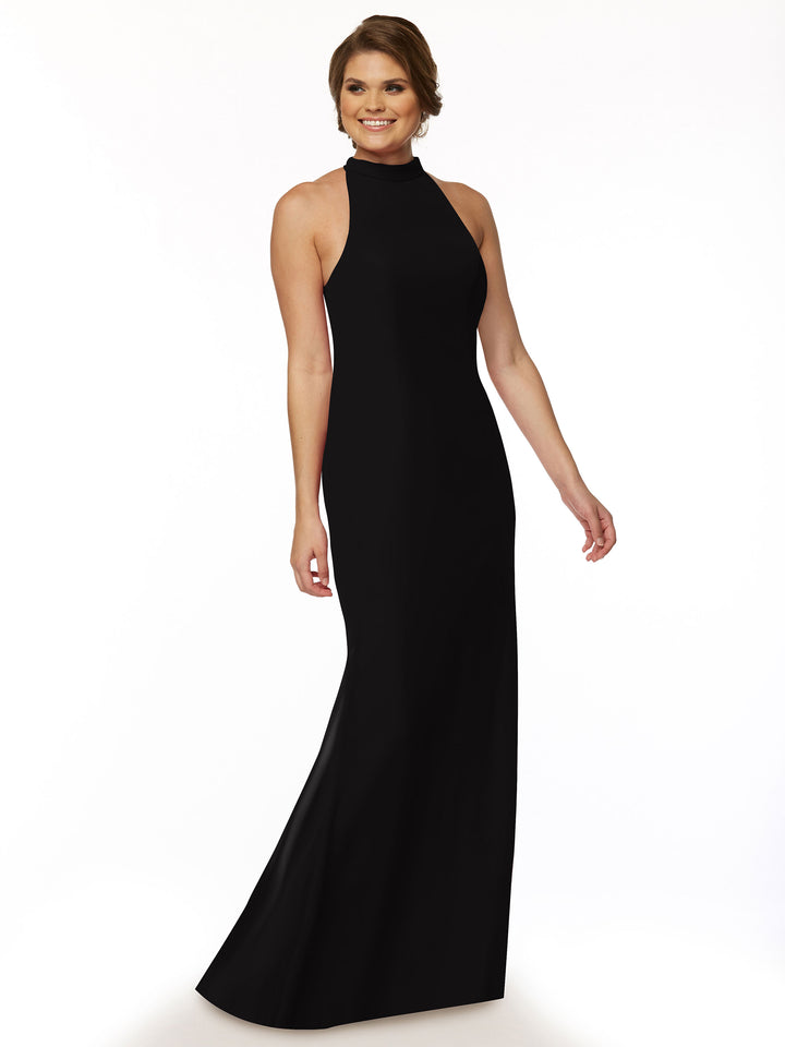 A woman stands against a white background, wearing the Avery Austin TH-80068 long black bridesmaid dress with a halter-neck. She has short, styled hair, smiles gently, and poses with one arm relaxed and the other slightly bent.