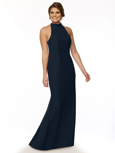 A woman models Avery Austin’s 80068, a long sleeveless navy blue open-back halter bridesmaid dress, smiling against a white background with short hair and one arm slightly bent.