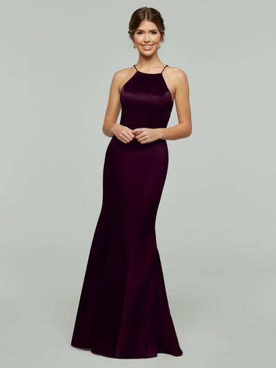 A woman smiles in the Avery Austin 80071, a sleeveless, floor-length deep purple dress with a halter neckline and flared skirt, set against a plain light gray background.