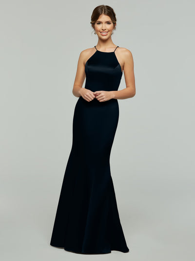 A woman smiles in the Avery Austin 80071, a sleeveless, floor-length dark navy dress with a flared skirt and halter neckline, set against a plain light gray background.