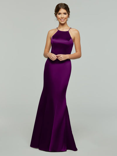 A woman smiles in the Avery Austin 80071, a sleek, floor-length dark purple satin gown with a fitted silhouette and halter neckline, set against a plain light gray background.