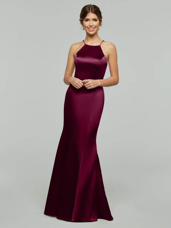 A woman models the Avery Austin 80071, a sleeveless, floor-length deep burgundy satin fitted dress with a halter neckline, standing and smiling against a plain light gray background.