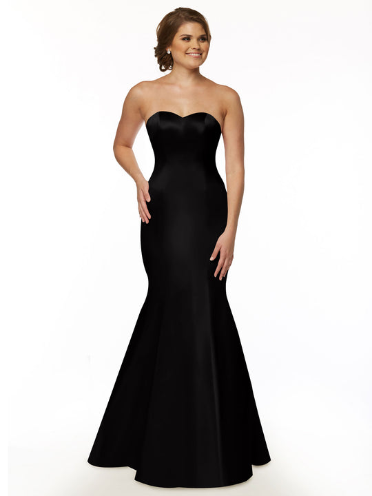 A woman smiles as she models Avery Austin's 80072, a black, strapless bridesmaid dress with a fitted bodice and flared, floor-length skirt. Her hair is styled back, highlighting the gown’s elegant silhouette.