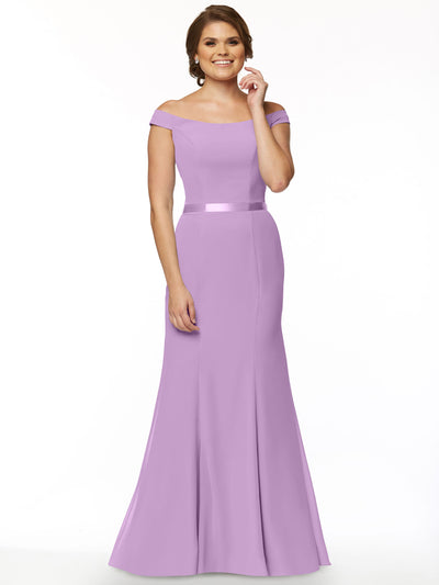 A woman smiles in Avery Austin's 80079—a floor-length, fitted lilac bridesmaid gown with an off-the-shoulder neckline and satin waistband—posed before a plain white background.