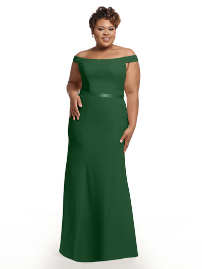 A woman smiles against a plain white background wearing Avery Austin's 80079, an off-the-shoulder, floor-length dark green chiffon bridesmaid dress.
