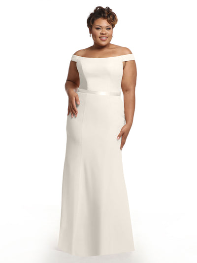 A woman models Avery Austin's 80079 dress, an off-the-shoulder bridesmaid gown with a fitted waist and floor-length skirt, smiling gracefully against a plain white background.