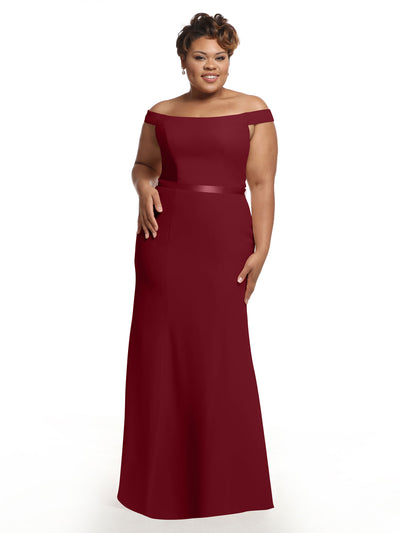 A woman models Avery Austin’s 80079, an off-the-shoulder burgundy bridesmaid dress with a fitted bodice and subtle flare hem, creating a timeless fit-and-flare silhouette against a plain white background.