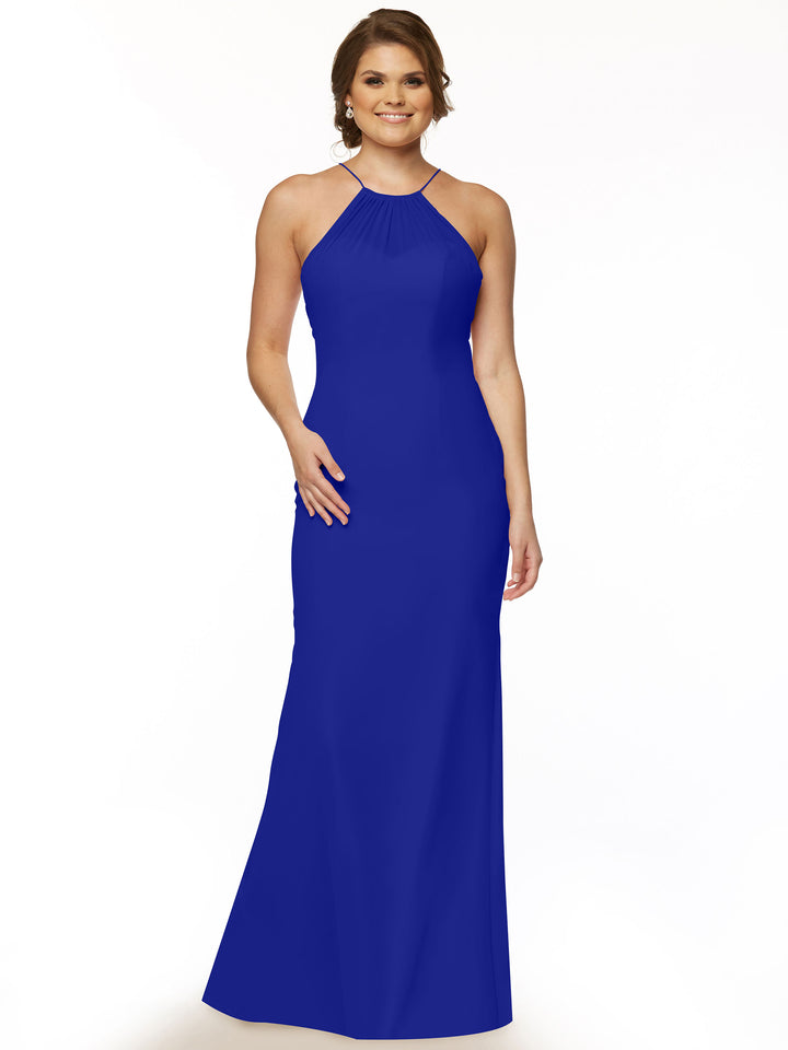 A woman smiles in the Avery Austin 80083, a sleeveless floor-length cobalt halter dress with a keyhole back, standing against a plain white background.