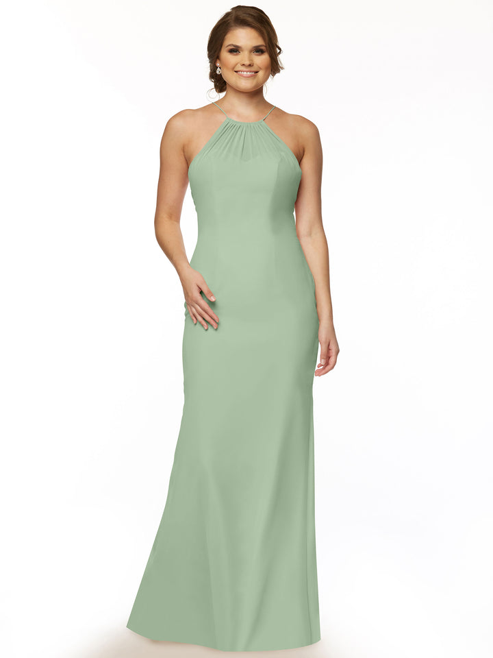 A woman with loose light brown waves smiles, wearing the Avery Austin TH-80083: a sleeveless, floor-length sage green chiffon halter dress with a keyhole back. She accessorizes lightly, posed against a plain white background.