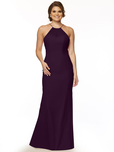 A woman smiles in the Avery Austin 80083, a sleeveless, floor-length chiffon halter dress in dark purple. She poses with loose waves in her hair against a plain white background.