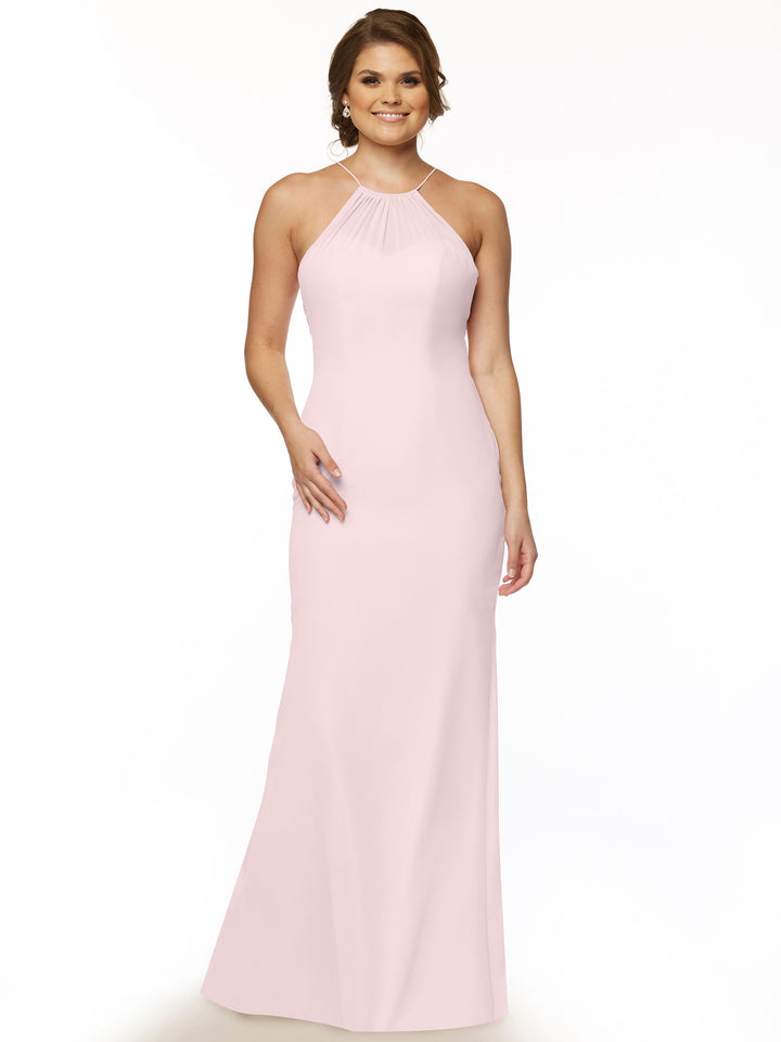 A woman smiles against a plain white background, wearing Avery Austin’s 80083—a sleeveless, floor-length light pink chiffon halter dress with a fitted silhouette and gathered neckline.
