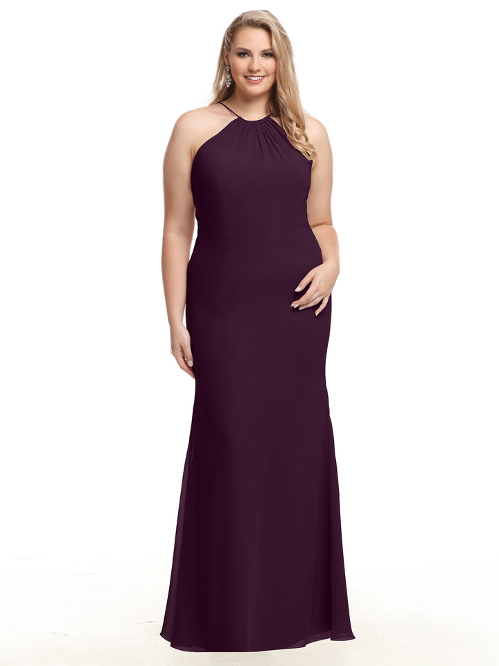 A woman wears the Avery Austin 80083, a sleeveless floor-length aubergine halter chiffon dress with a keyhole back, standing and smiling against a white background.
