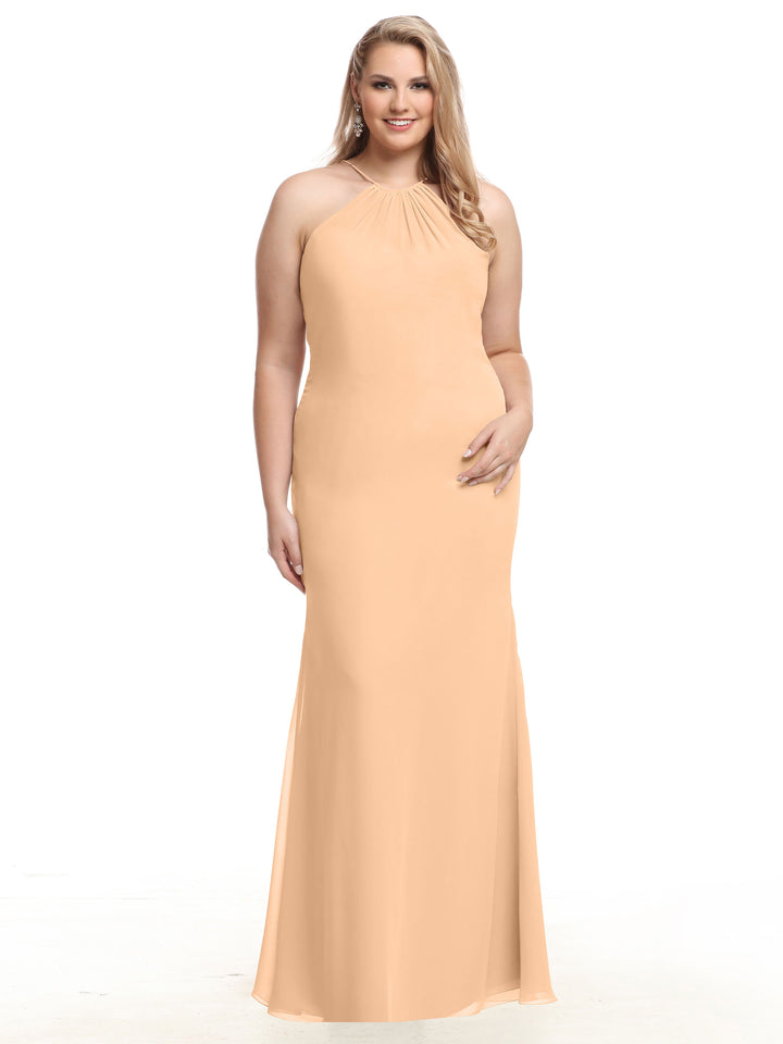 A woman wears Avery Austin style 80083, a blush sleeveless halter chiffon dress with a fitted bodice, slight flare at the hem, and elegant keyhole back, smiling against a plain white background.